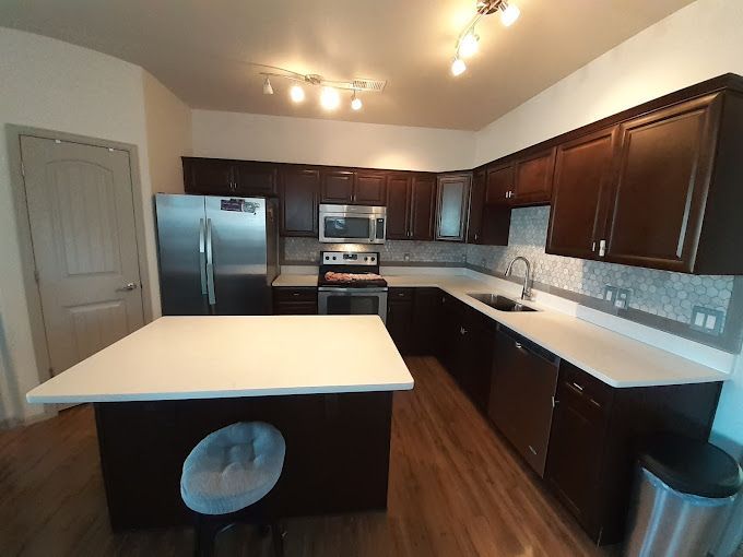 A kitchen with brown cabinets and stainless steel appliances