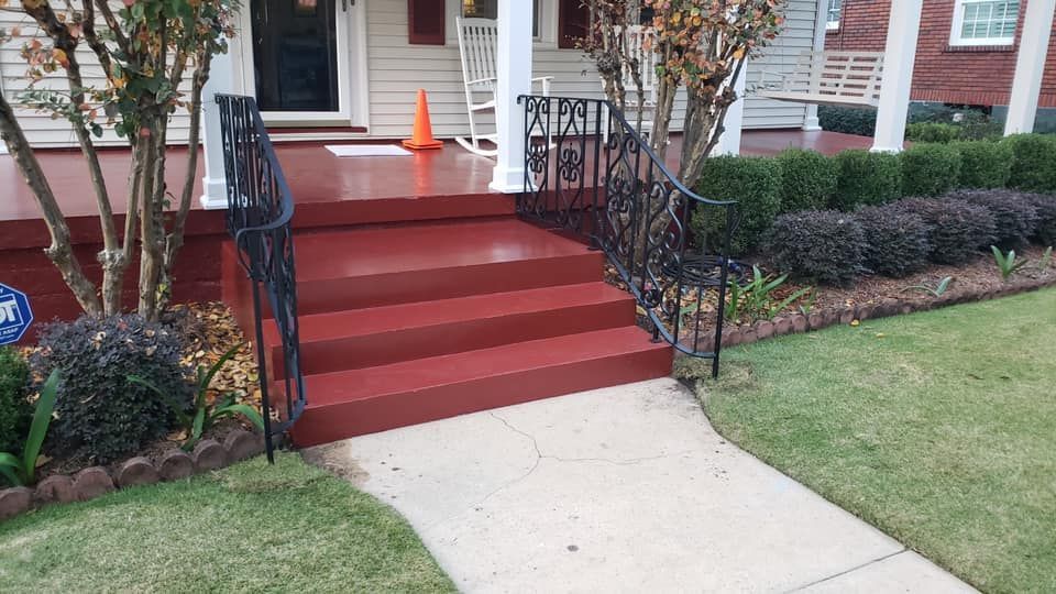 A house with red steps and a wrought iron railing