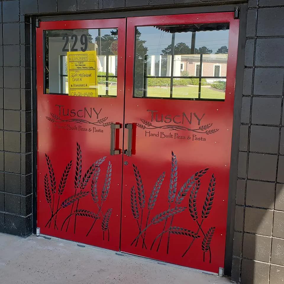 A red door with tuscany written on it