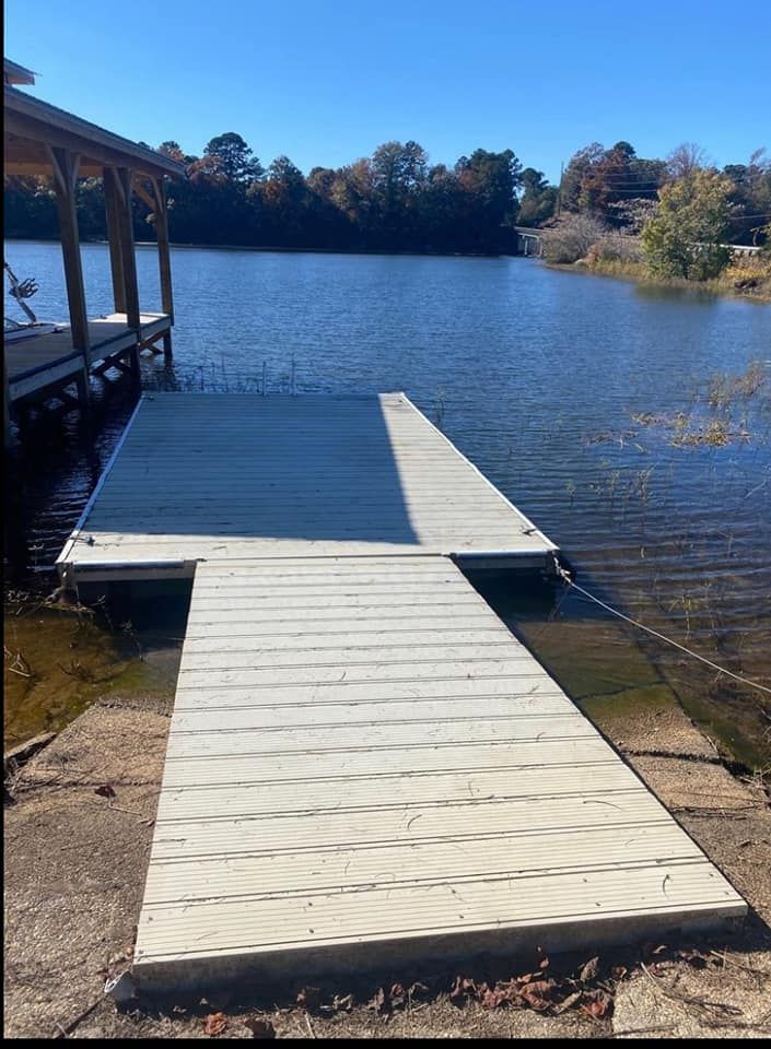 A dock is sitting on the shore of a lake.