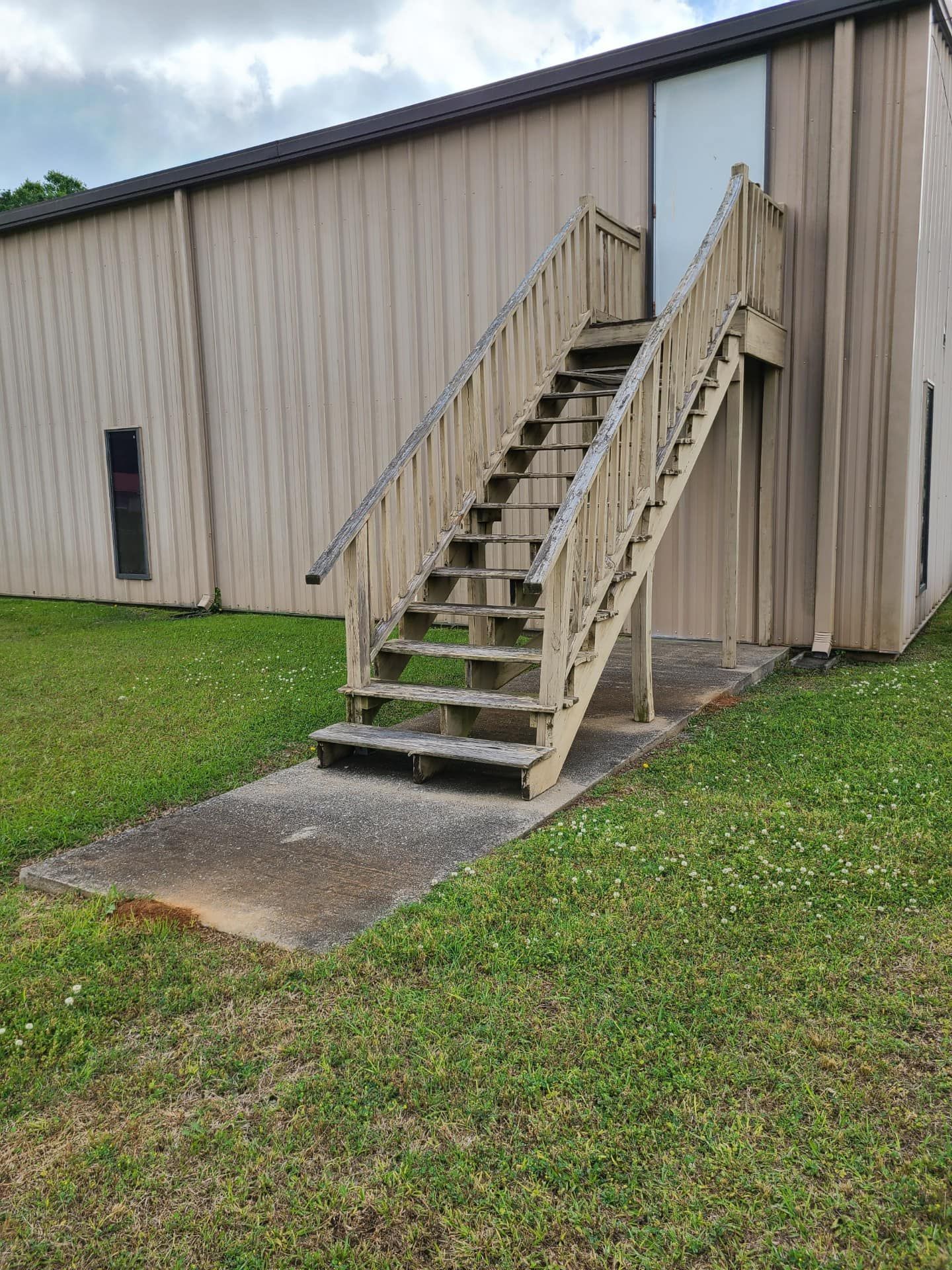A set of wooden stairs leading up to a building.