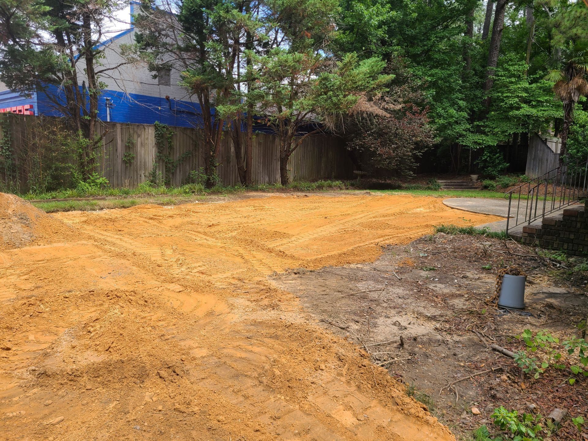 There is a lot of dirt in the middle of the yard.