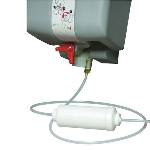 Close-up of a gray water tank with a red valve, tubing, and a white water filter.