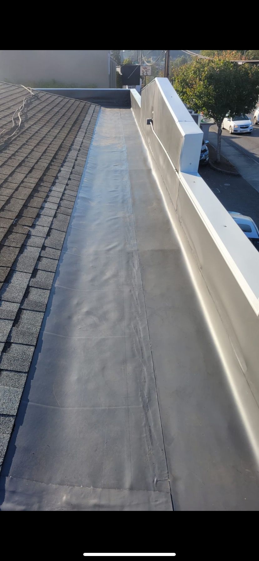 Grey Metallic Gutter On Asphalt Shingles Roof
