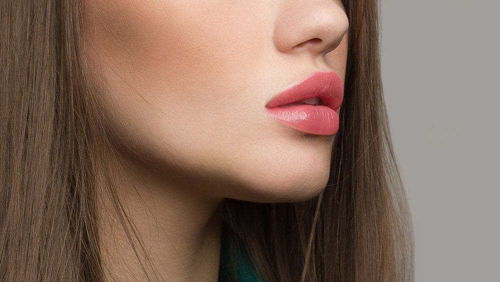 A Close up Of a Woman's Face with Long Hair and Pink Lips — Skin Exquisite Laser & Cosmetic Clinic in Port Macquarie, NSW