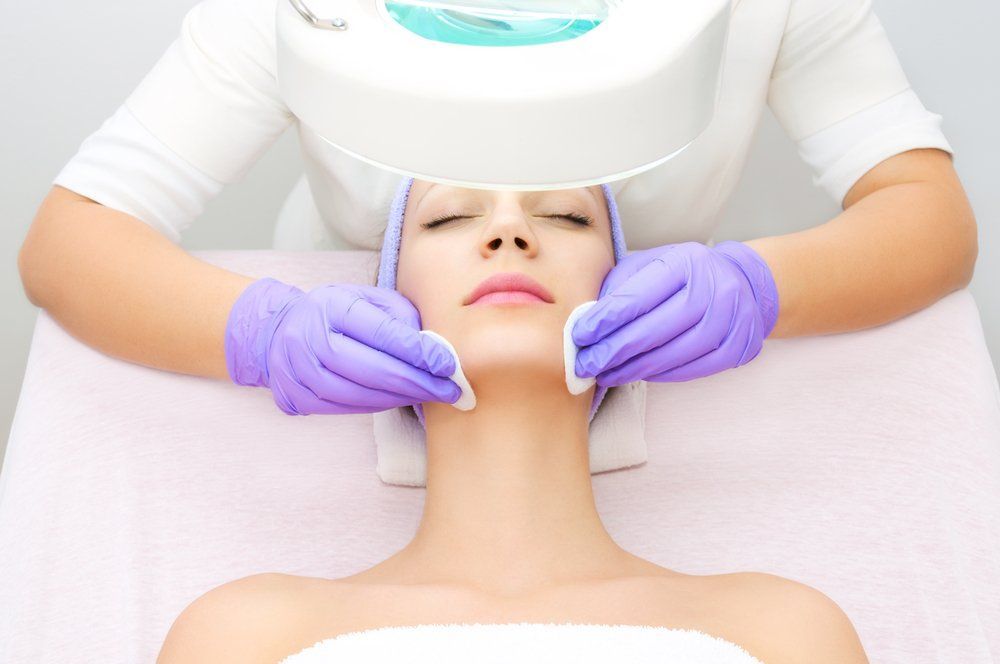 A Woman Is Getting a Facial Treatment at A Beauty Salon — Skin Exquisite Laser & Cosmetic Clinic in Port Macquarie, NSW