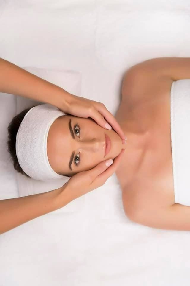 A Woman Is Getting a Facial Massage at A Spa — Skin Exquisite Laser & Cosmetic Clinic in Port Macquarie, NSW