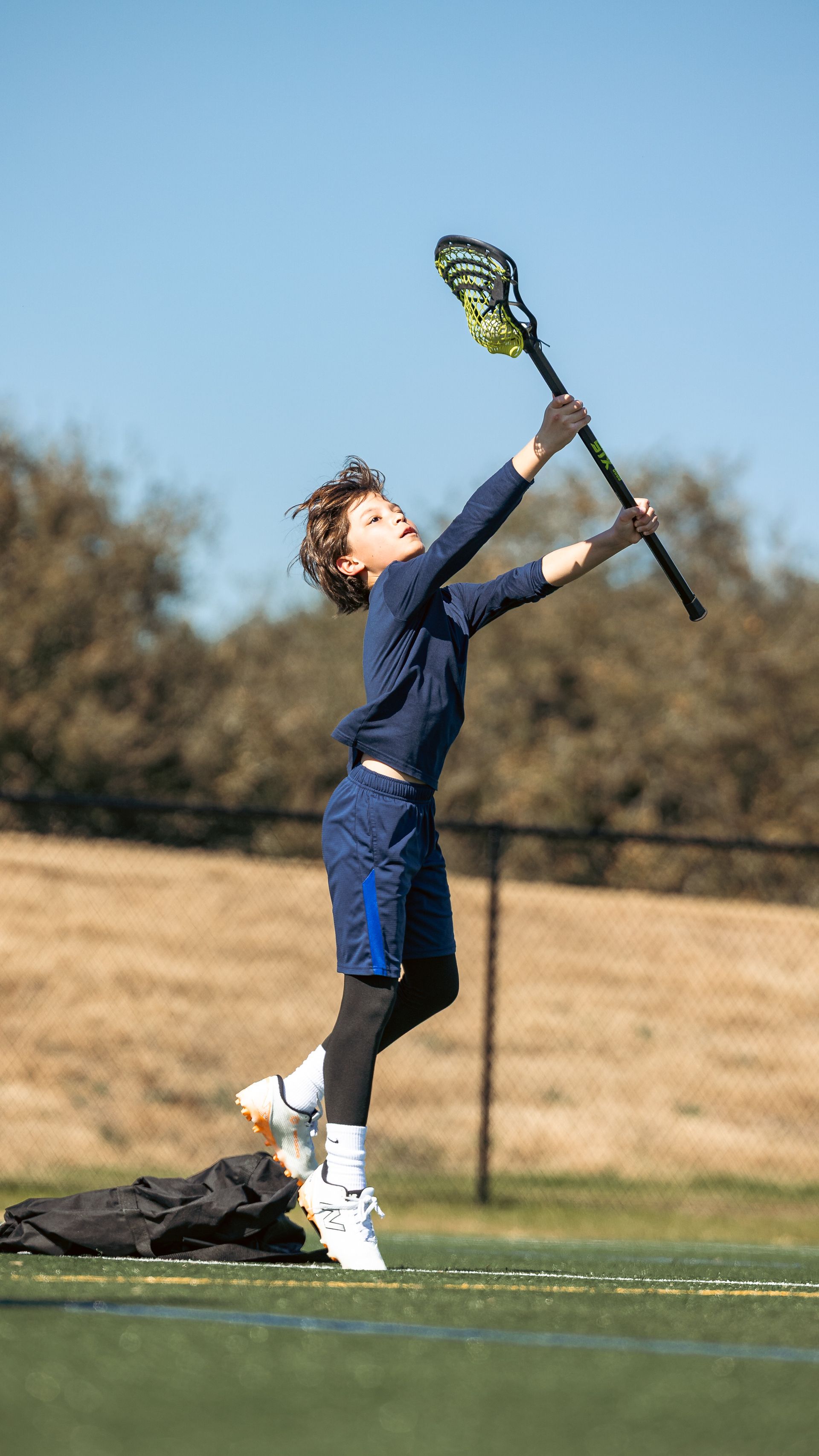 Albion Lacrosse Club player taking a shot on a field