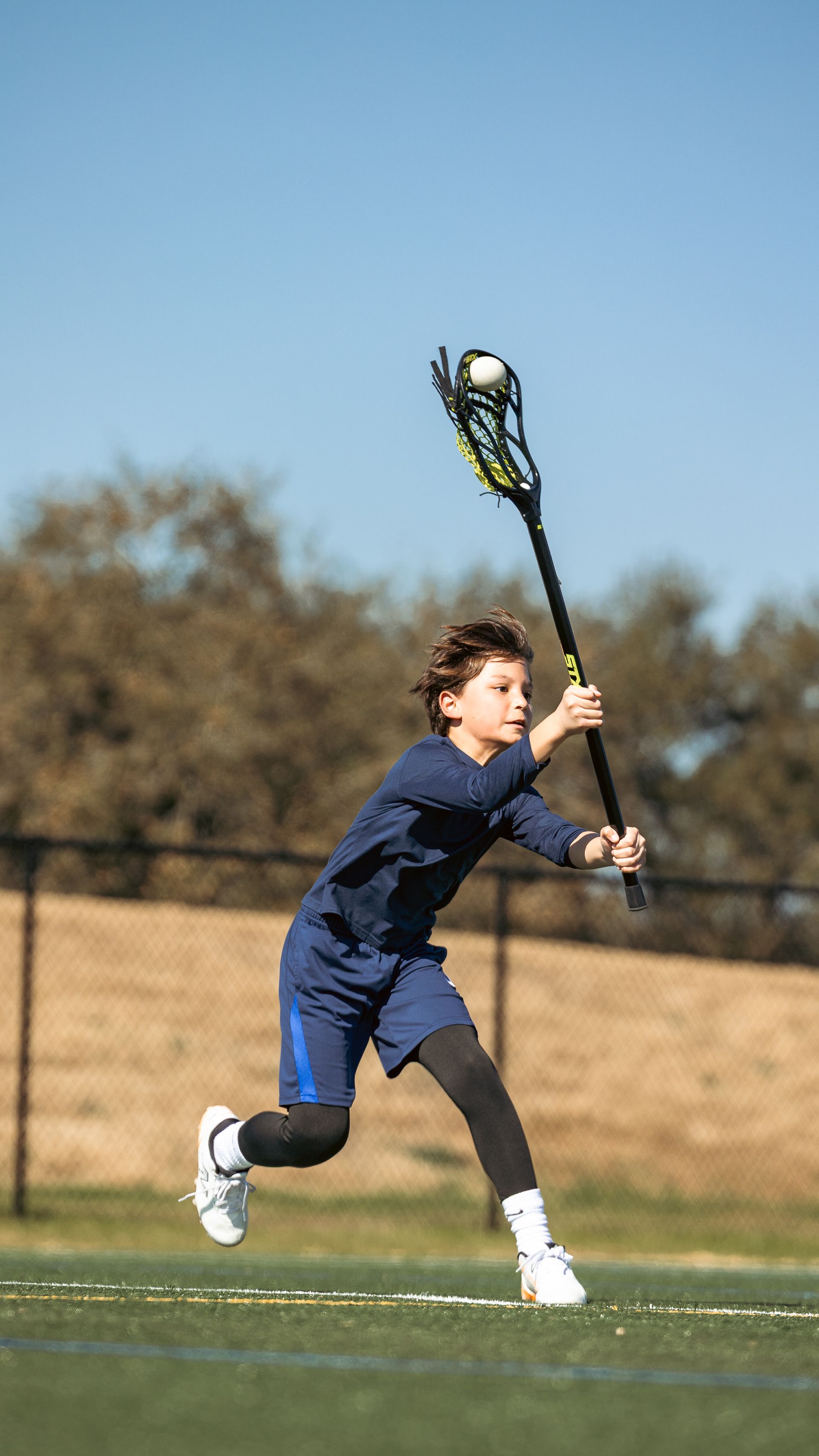 Albion Lacrosse Club player running on the field