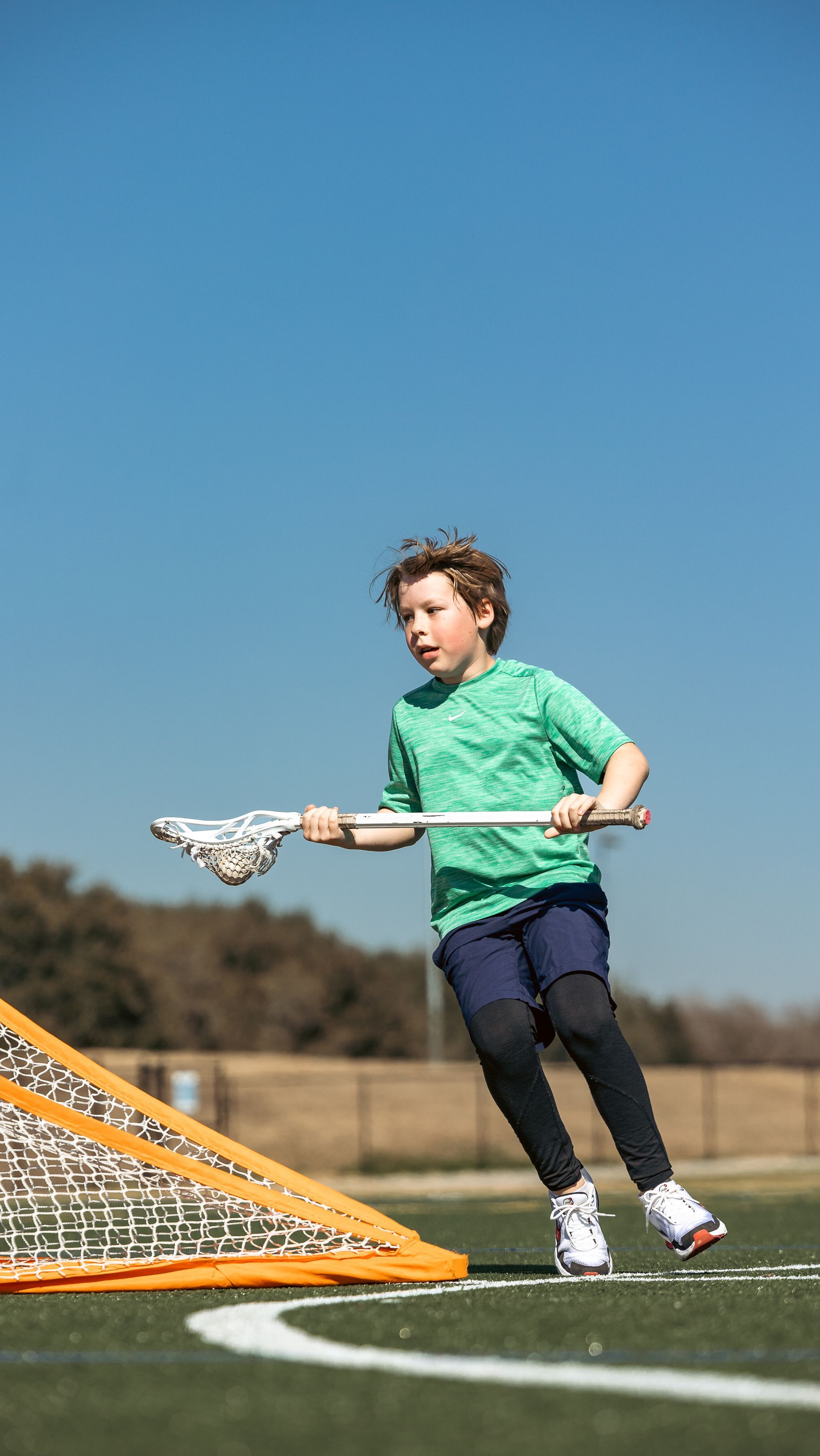 Albion Lacrosse Club player running with the ball