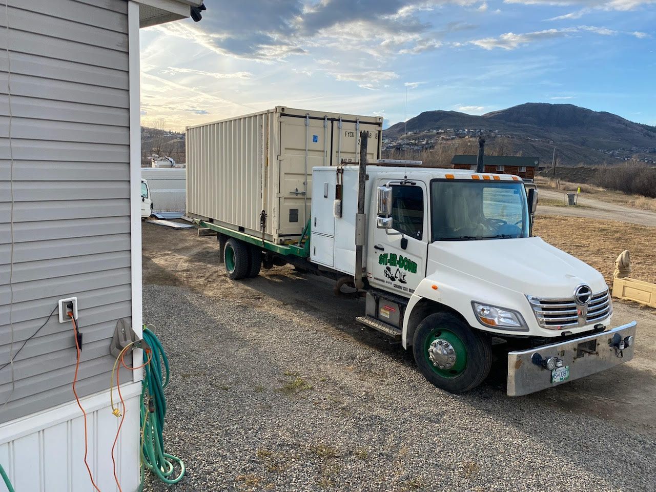 sea-can shipping container loaded onto Git-Er-Done Towing truck