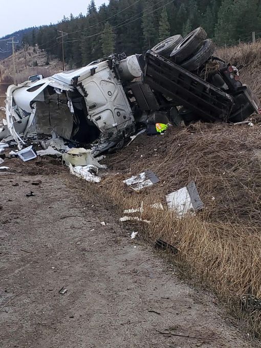 Large truck wrecked on the side of the road