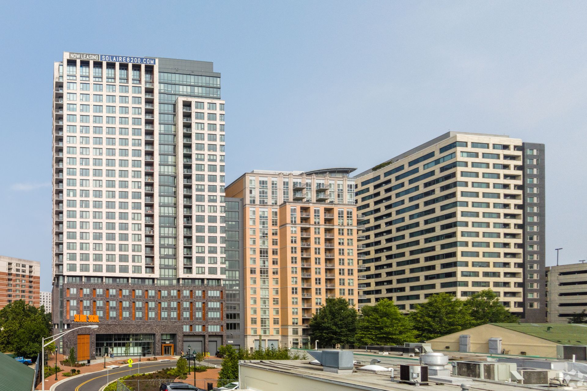 A group of tall buildings are sitting next to each other in a city.