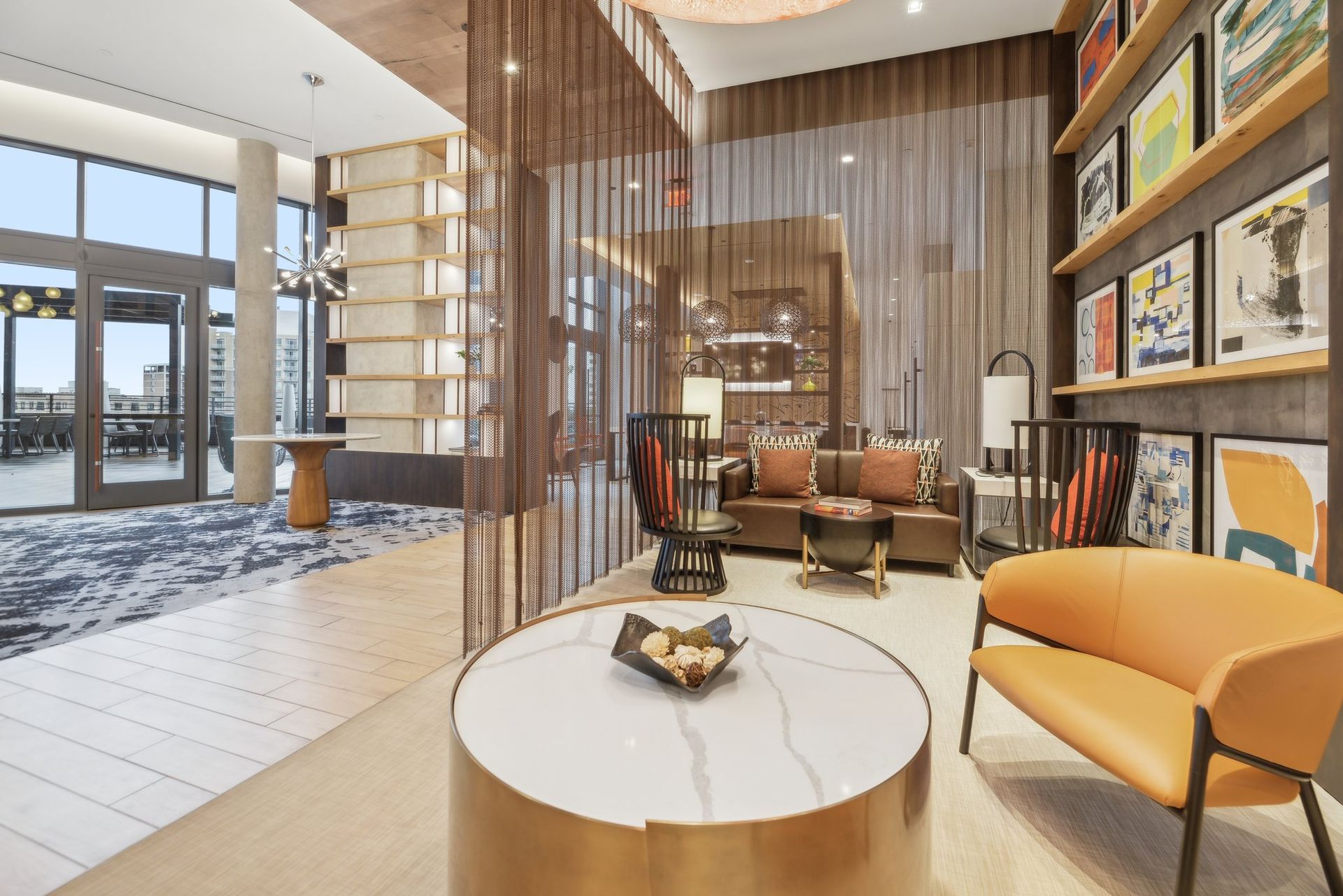 Modern clubhouse with a couch, table, chairs, and curtains at Solaire 8200 Dixon offers apartments in Silver Spring, MD.