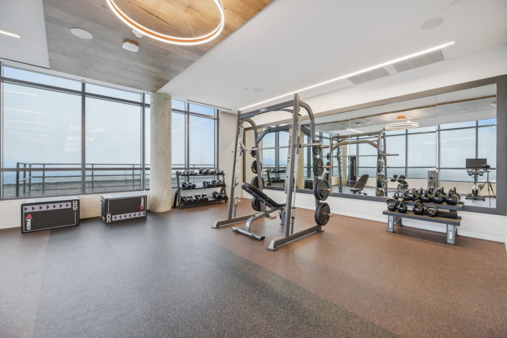 A large gym with a lot of windows and exercise equipment at Solaire 8200 Dixon offers apartments for rent in Silver Spring, MD.