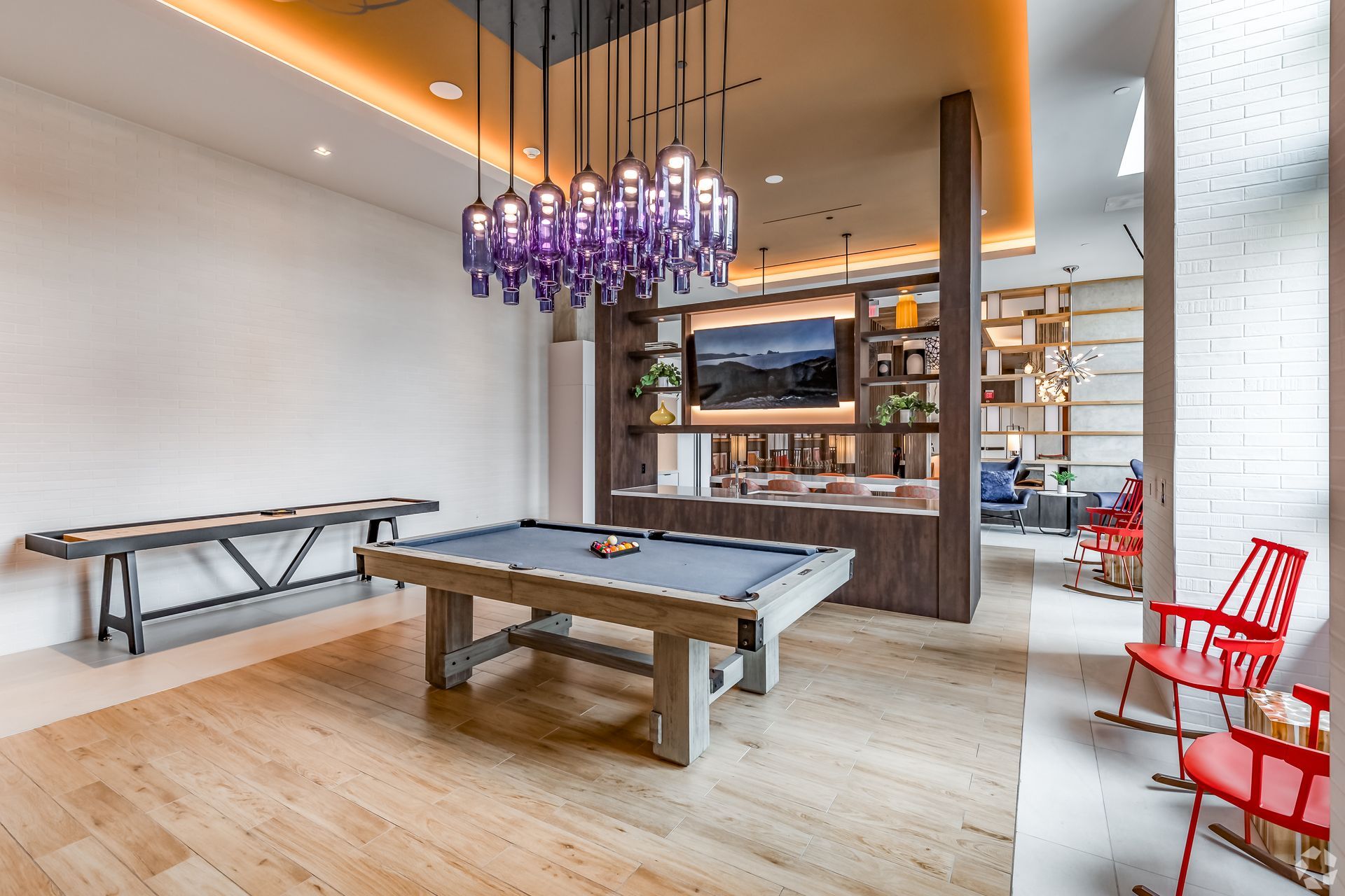 There is a pool table in the middle of the clubroom at Solaire 8200 Dixon offers apartments in Silver Spring, MD.