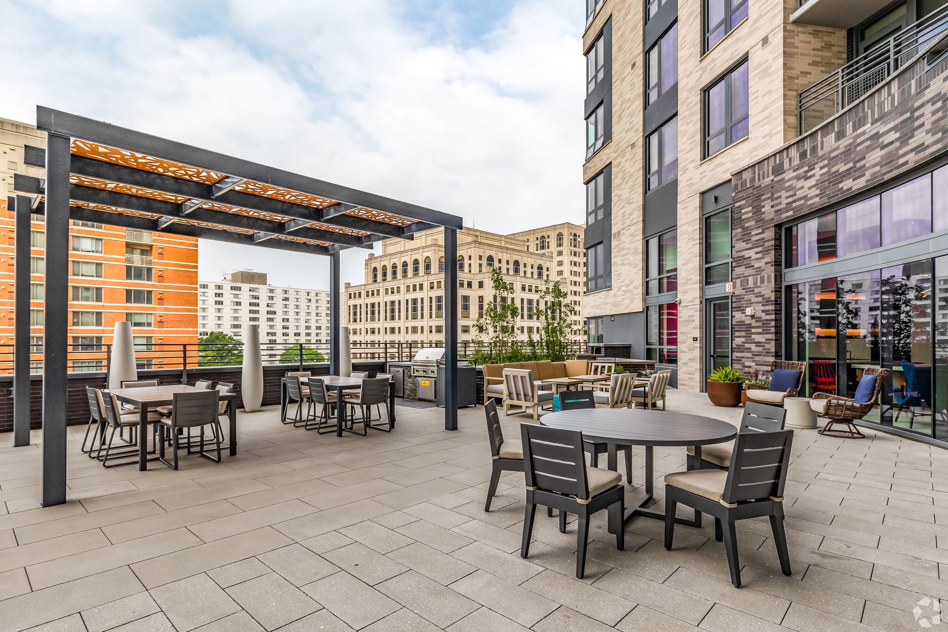 A patio with tables and chairs in front of a building.