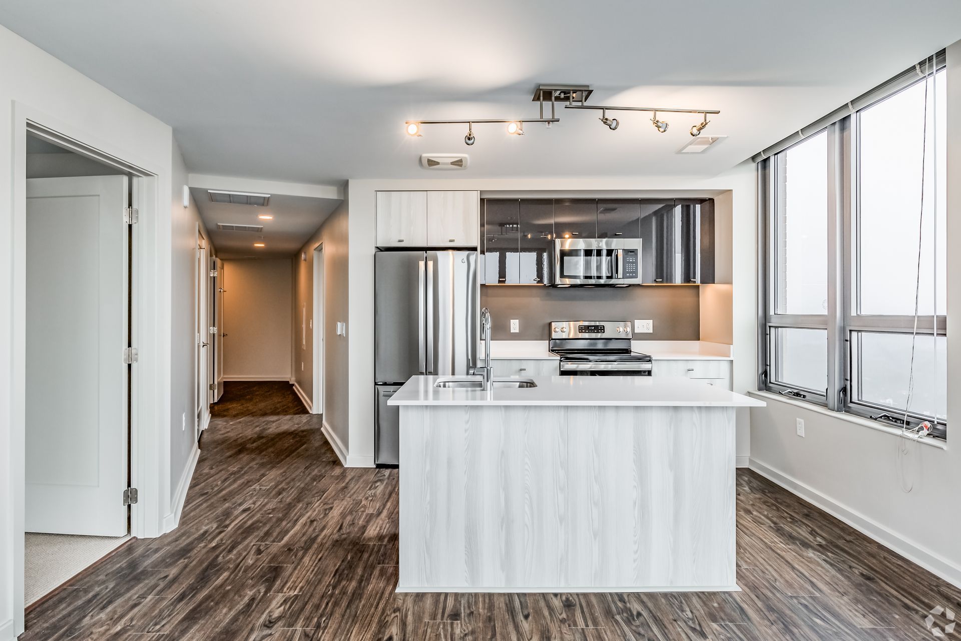 A kitchen with a large island and stainless steel appliances at Solaire 8200 Dixon offers apartments in Silver Spring, MD.