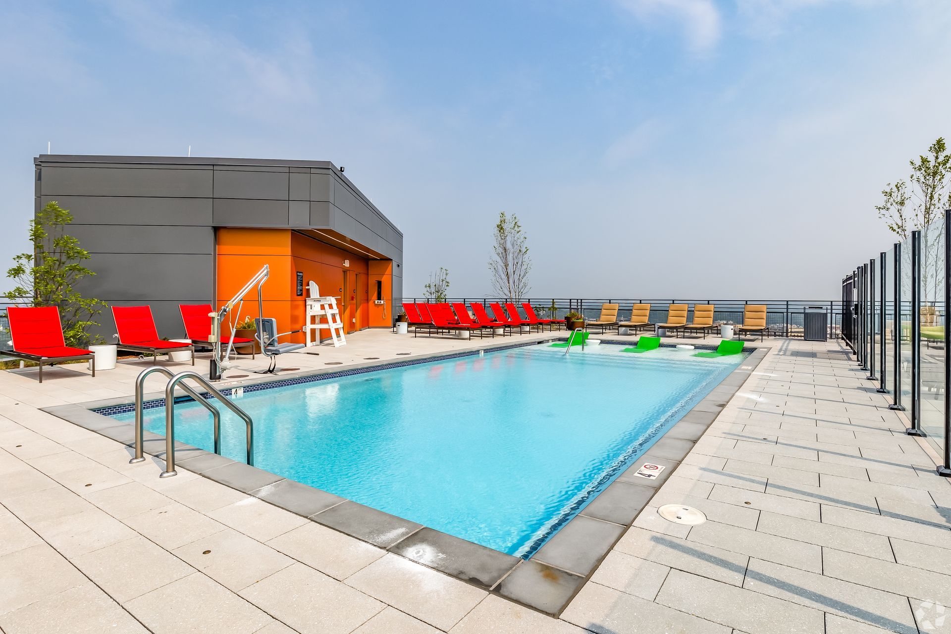 A large swimming pool on the roof of a building at Solaire 8200 Dixon offers high-rise apartments in Silver Spring, MD.