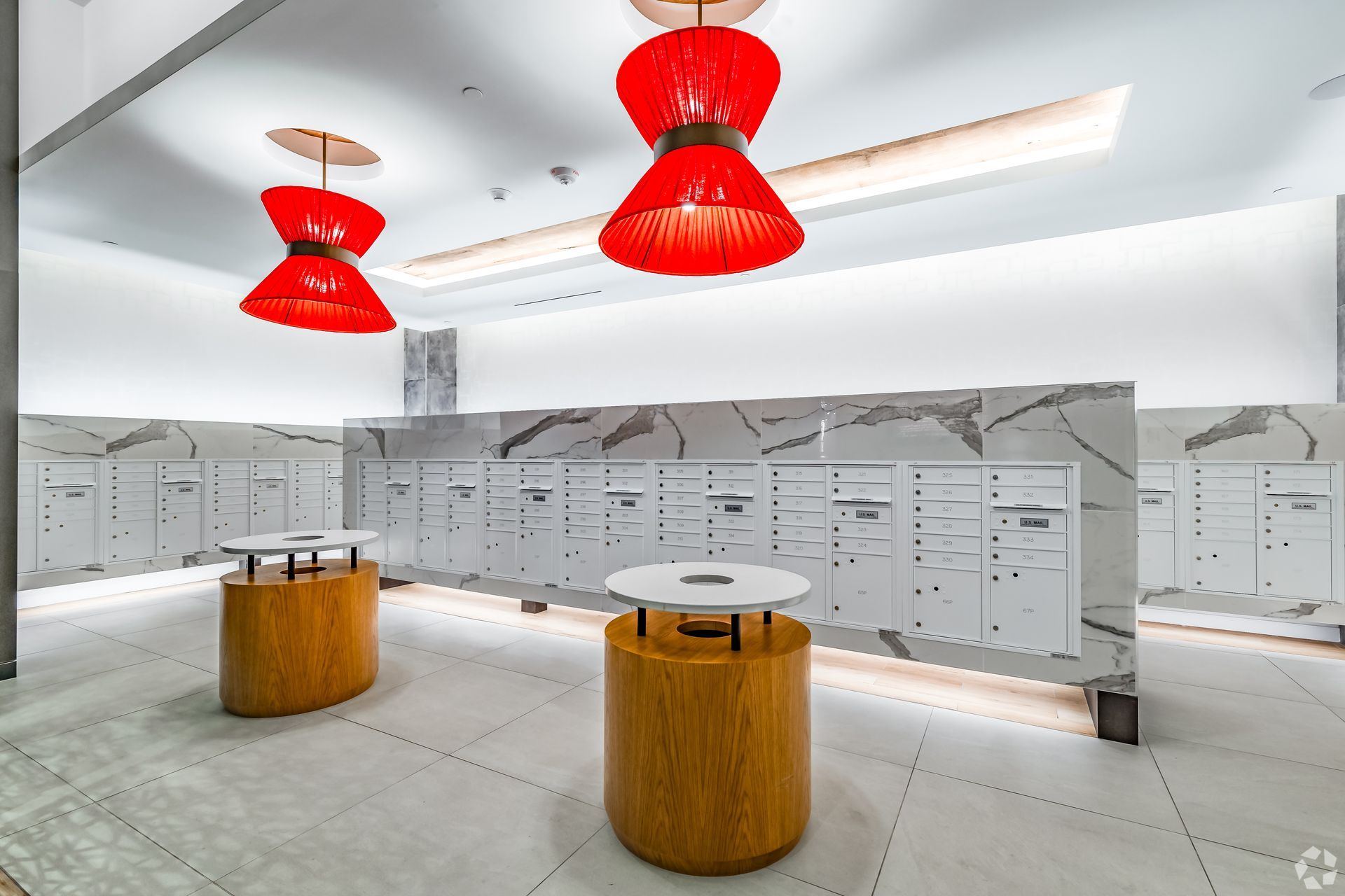 A large room with a lot of lockers and tables.