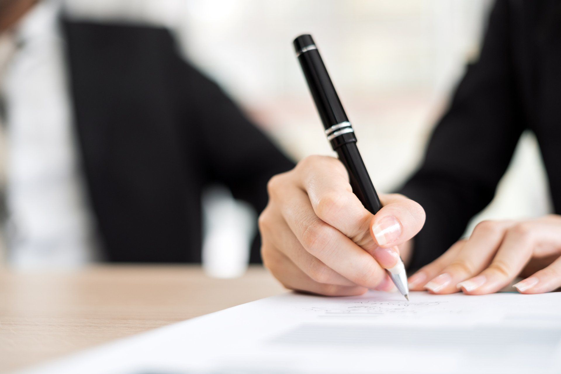 Woman Signing Contract - Appleton, WI - Bollenbeck & Fyfe S.C.