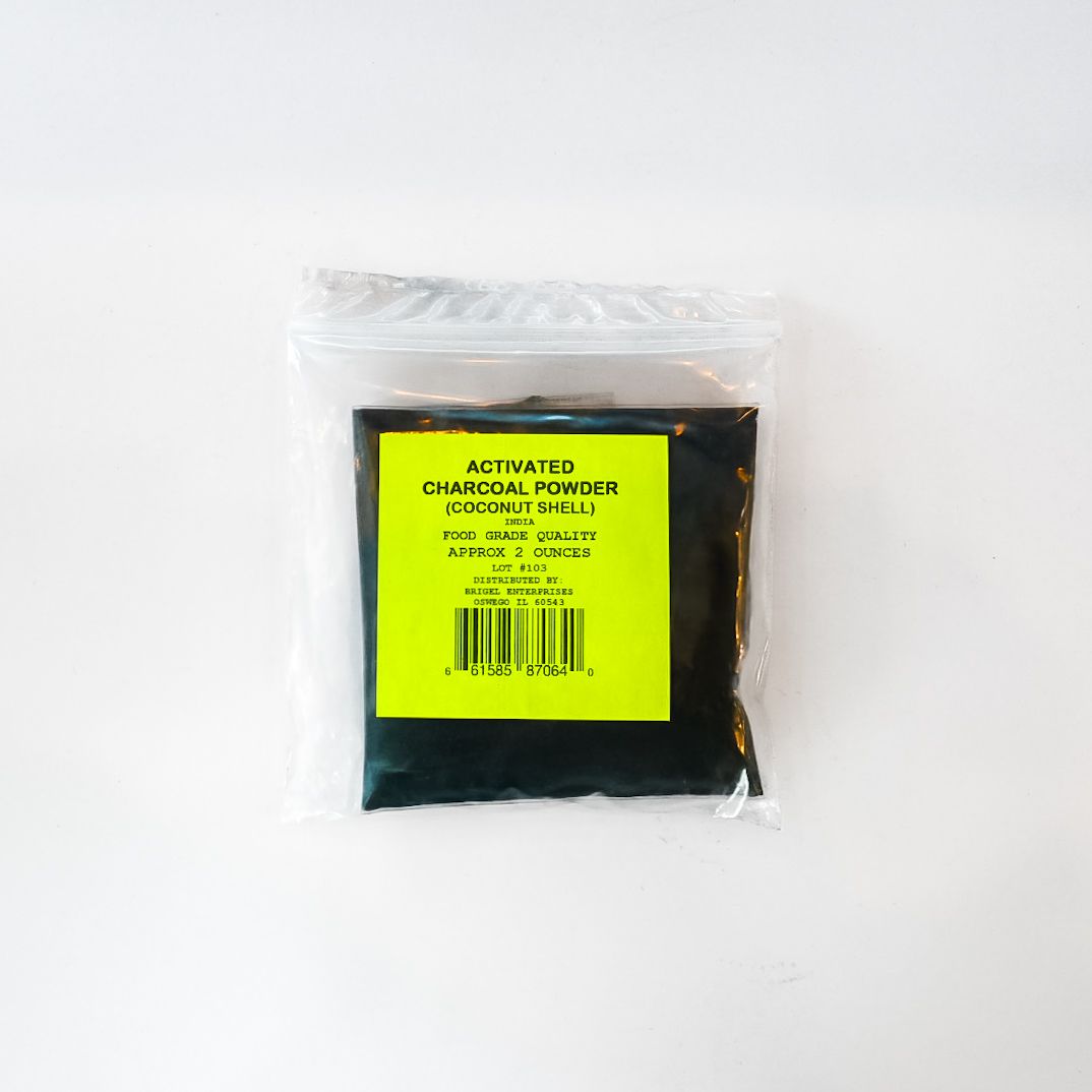 Sealed black packet with a bright yellow label on a white background