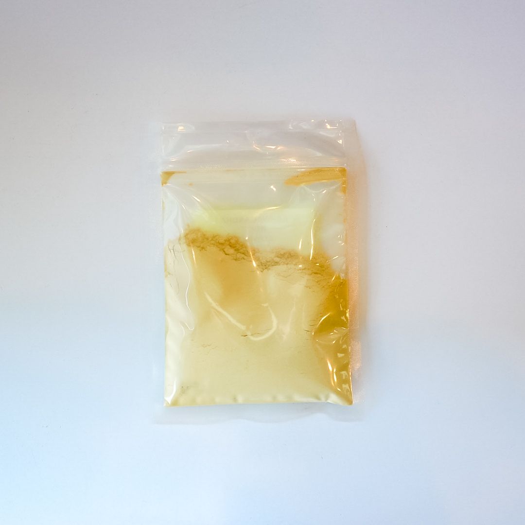 Clear plastic bag with yellow label containing a pale food item on a white background