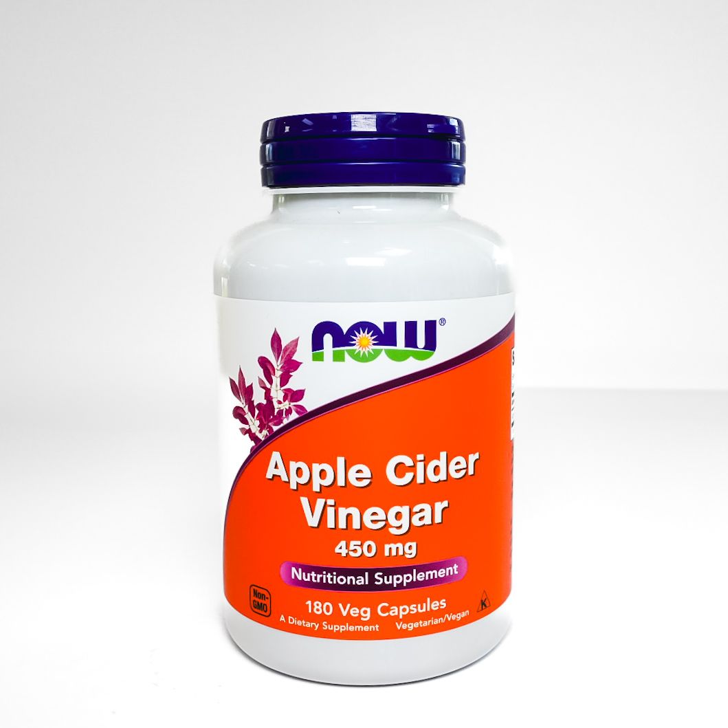 NOW Apple Cider Vinegar supplement bottle with purple cap and orange label on white background