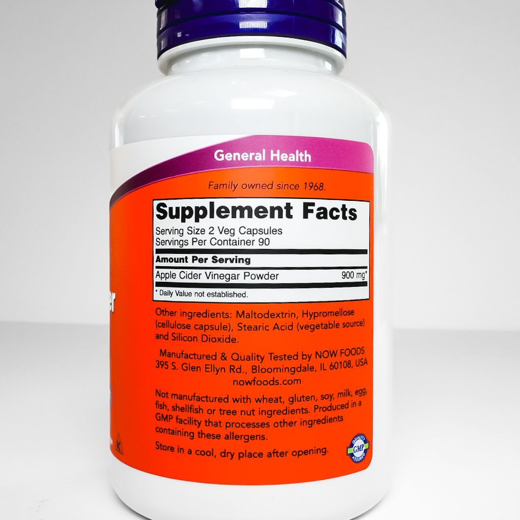 NOW Apple Cider Vinegar supplement bottle with purple cap and orange label on white background