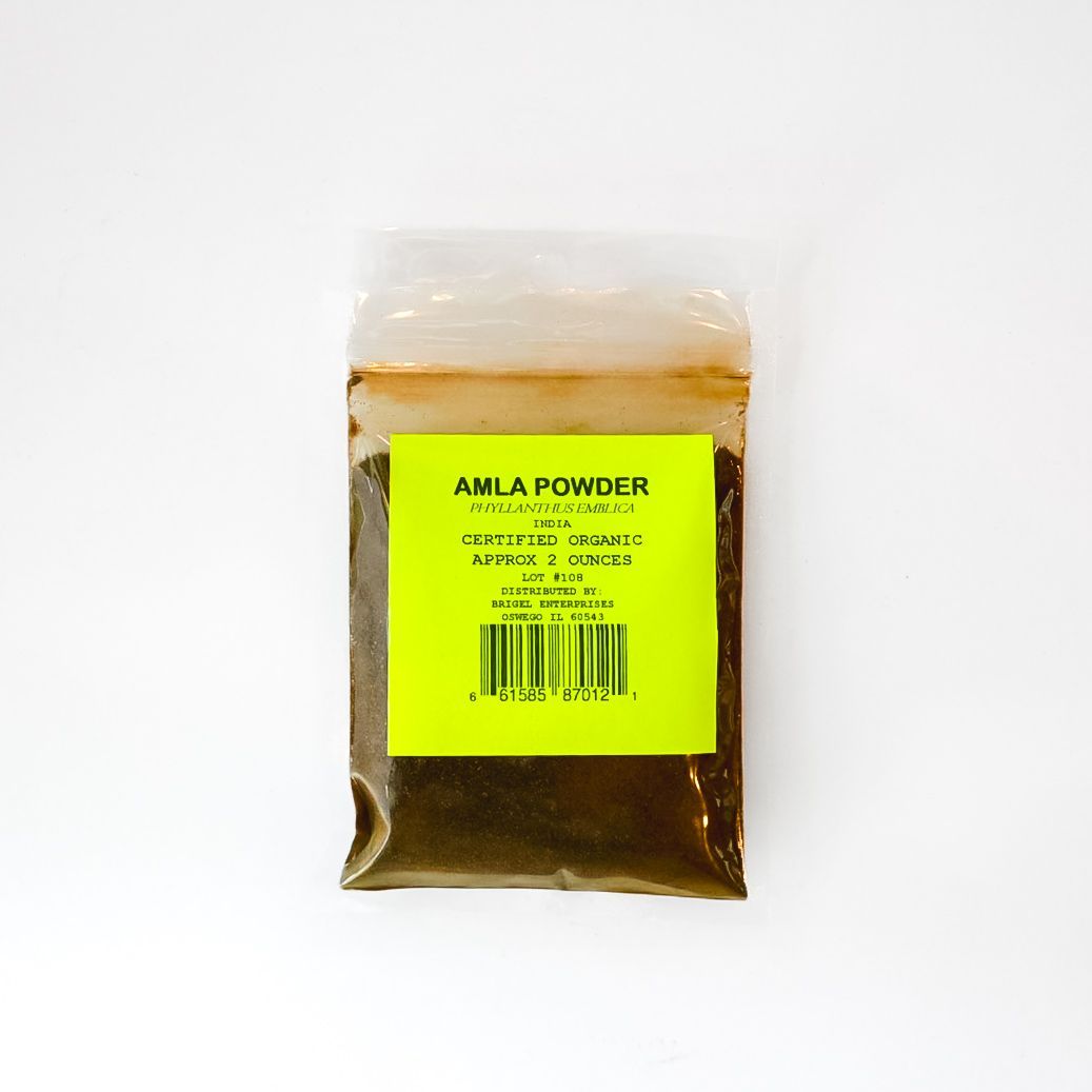 Small clear pouch of amla powder with a bright yellow label on a white background