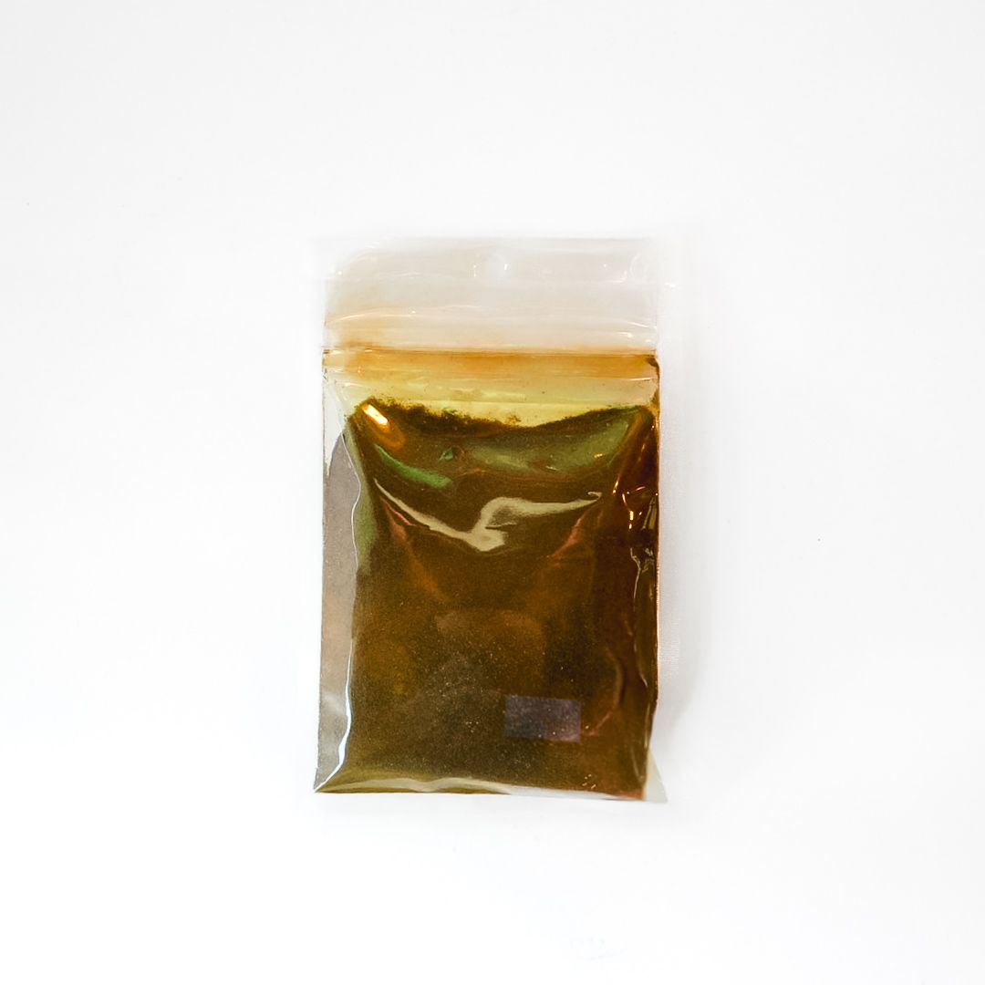 Small clear pouch of amla powder with a bright yellow label on a white background
