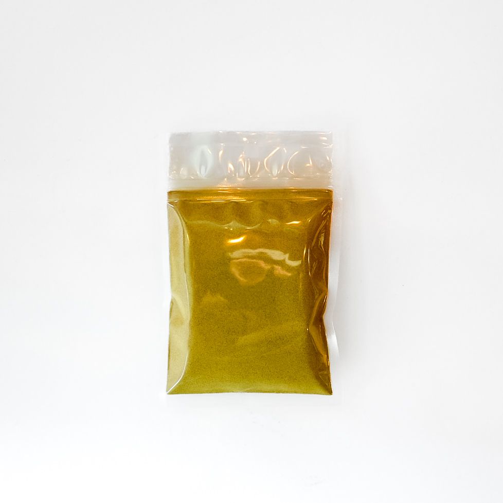 Small plastic pouch of yellow aloe vera leaf powder with a bright green label on a white background