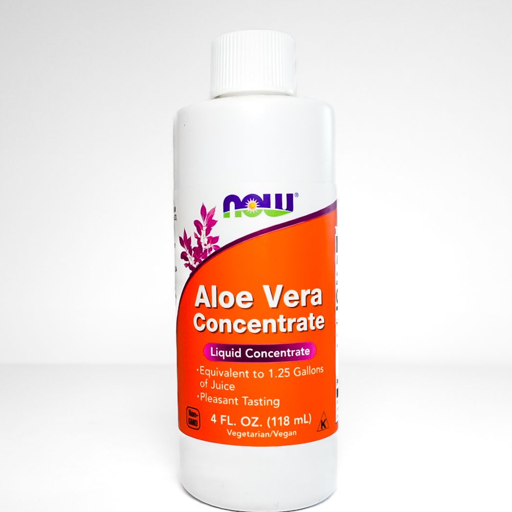 White bottle of NOW Aloe Vera Concentrate with orange label on a plain background