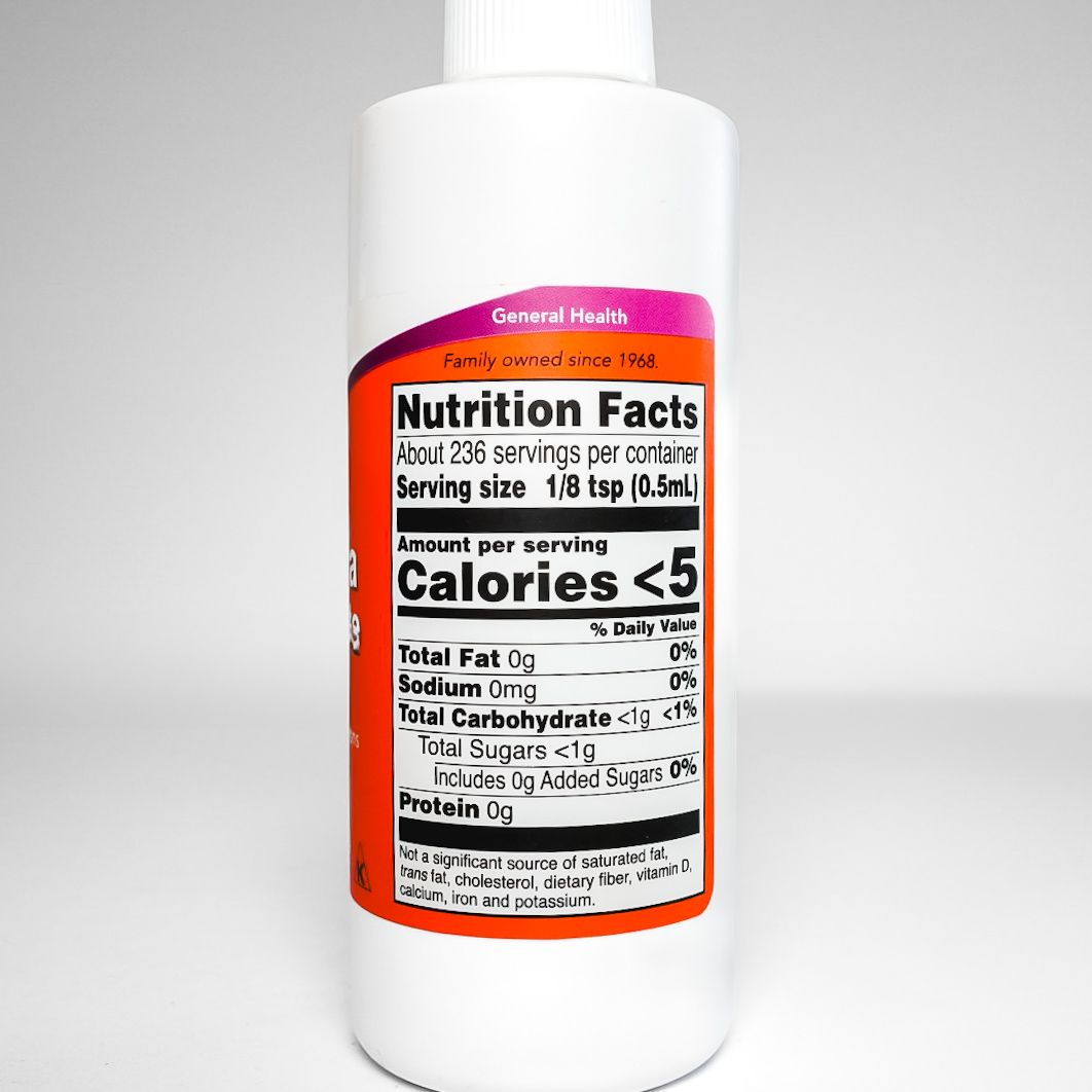 White bottle of NOW Aloe Vera Concentrate with orange label on a plain background