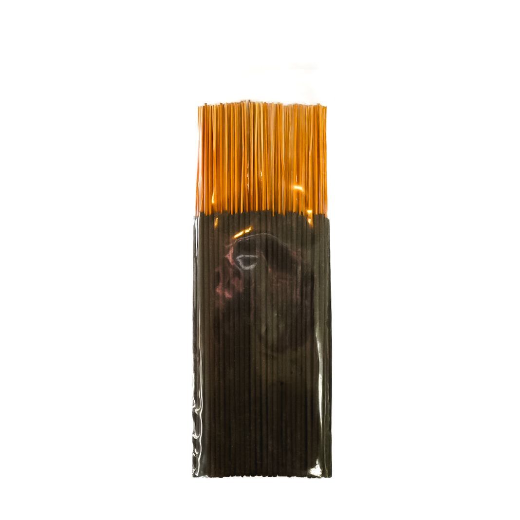 Bundle of black incense sticks in a clear plastic sleeve with a yellow label on a white background