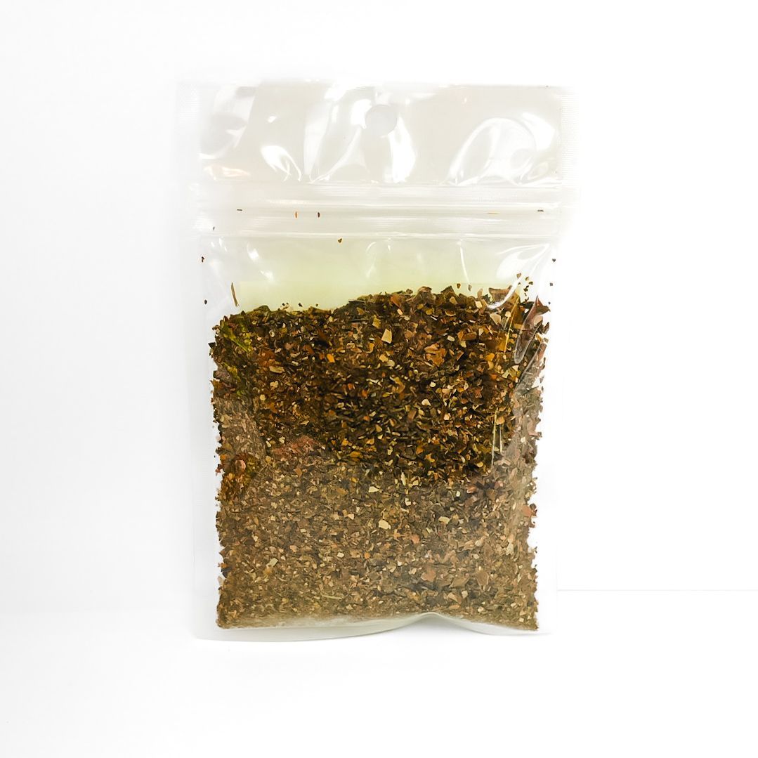 Clear plastic bag of dried herbs with a bright yellow label and barcode on a white background