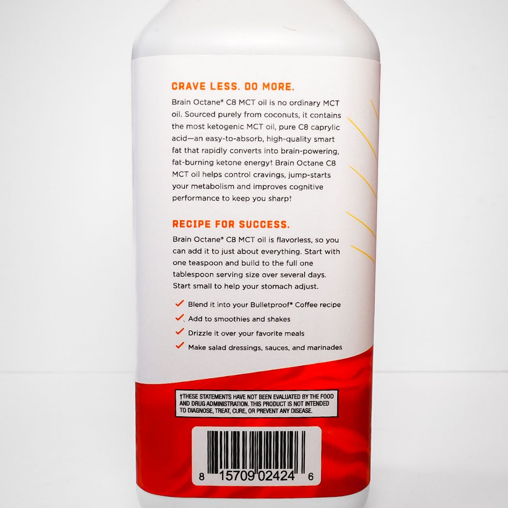 White Bulletproof Brain Octane C8 MCT oil bottle with red label on a light background
