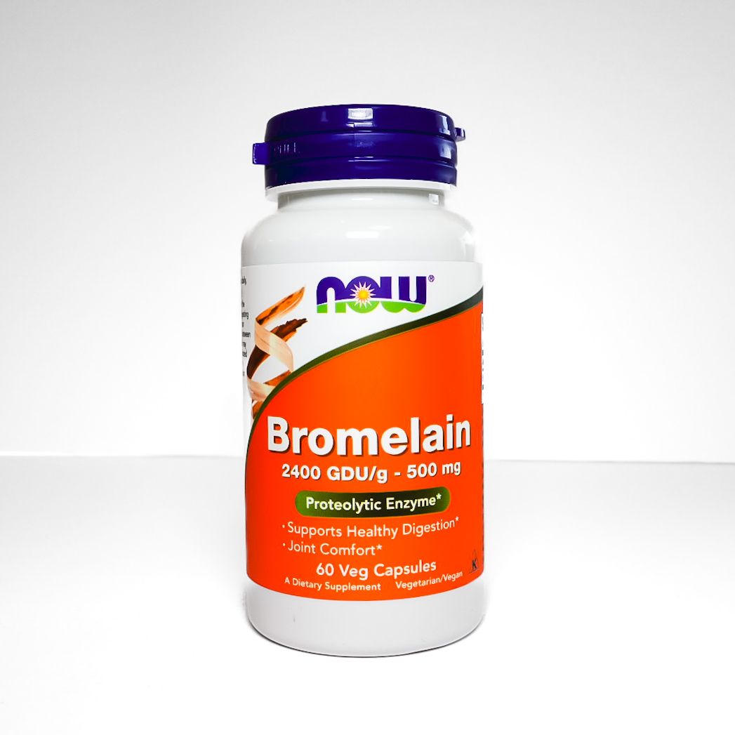 NOW Bromelain dietary supplement bottle with purple cap and orange label on a white background
