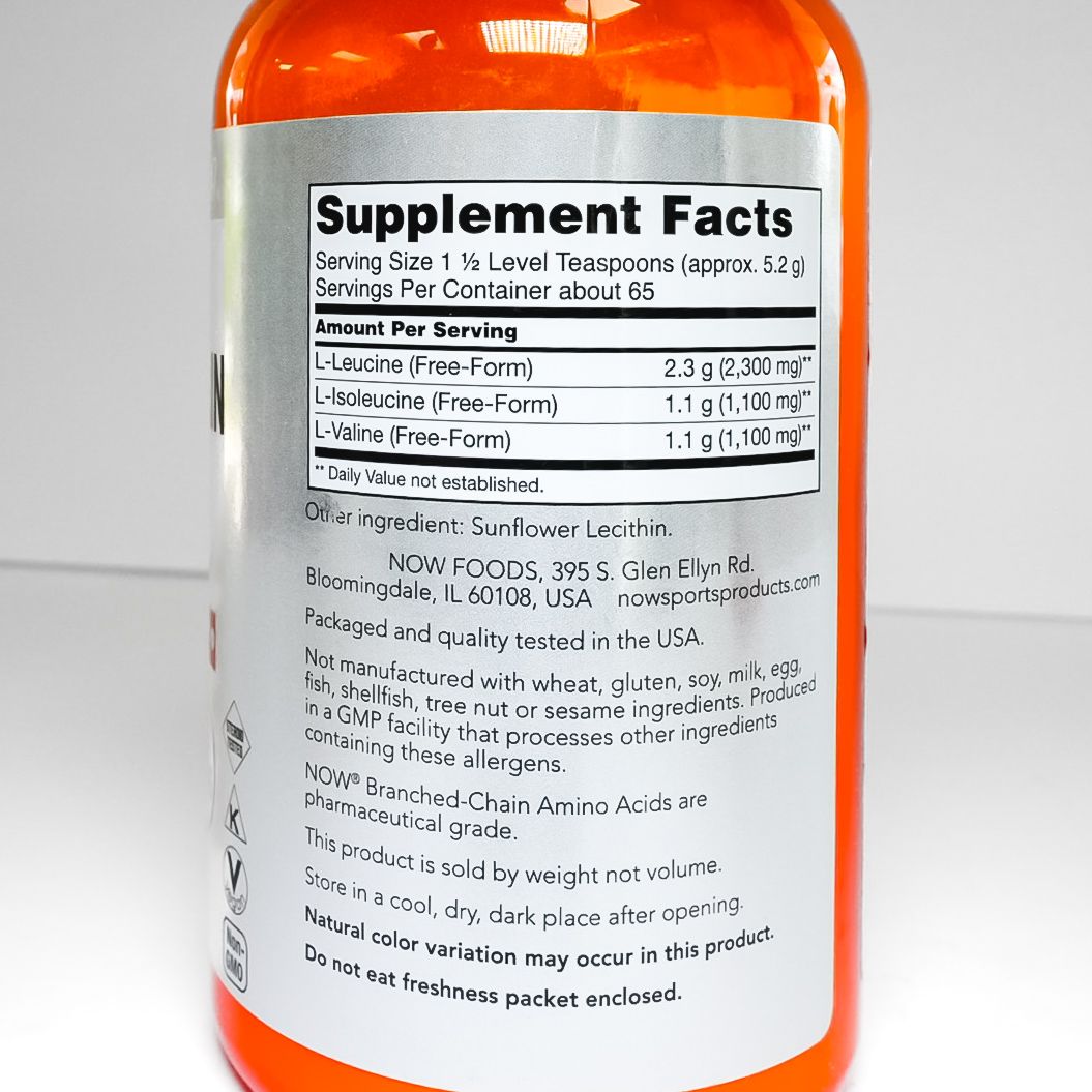 NOW Sports branched-chain amino acid powder bottle with orange cap and white label