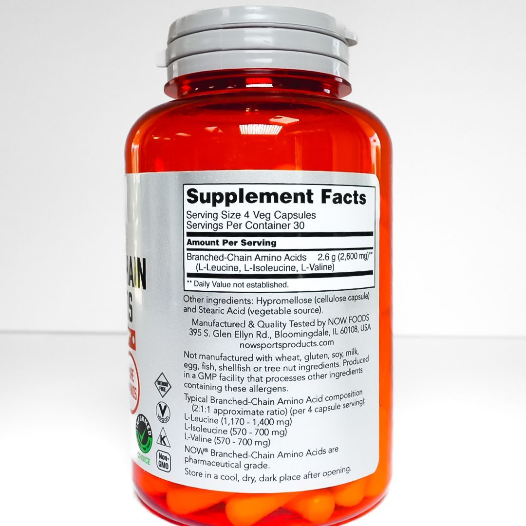 NOW Branched-Chain Amino Acids dietary supplement bottle with orange-red label and silver cap