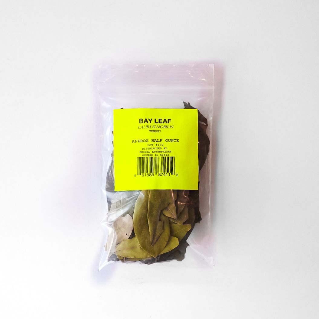 Clear plastic bag of dried leaves with a bright yellow label on a white background