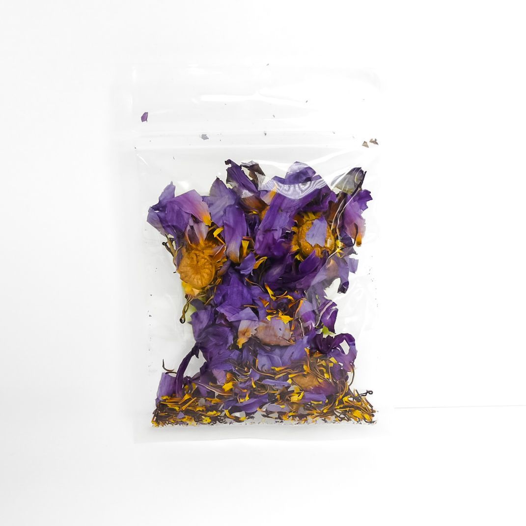 Bag of dried blue lotus flowers with a bright yellow label on a white background