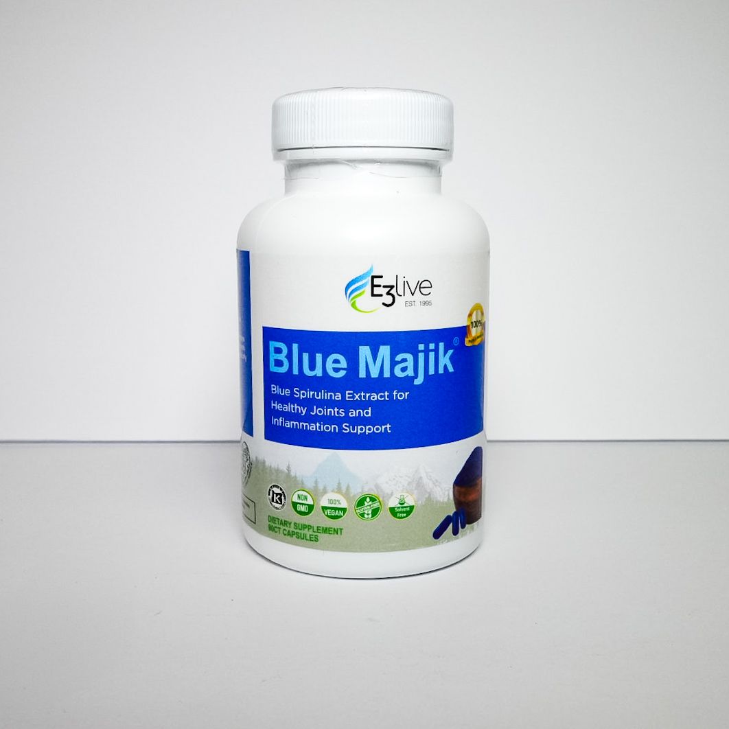 White bottle of Blue Majik dietary supplement with blue and green label on a plain background