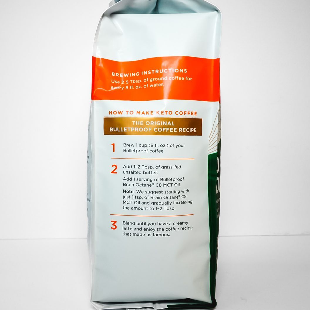 Bulletproof Original Decaf coffee bag, white and green with orange label, standing upright on a plain background