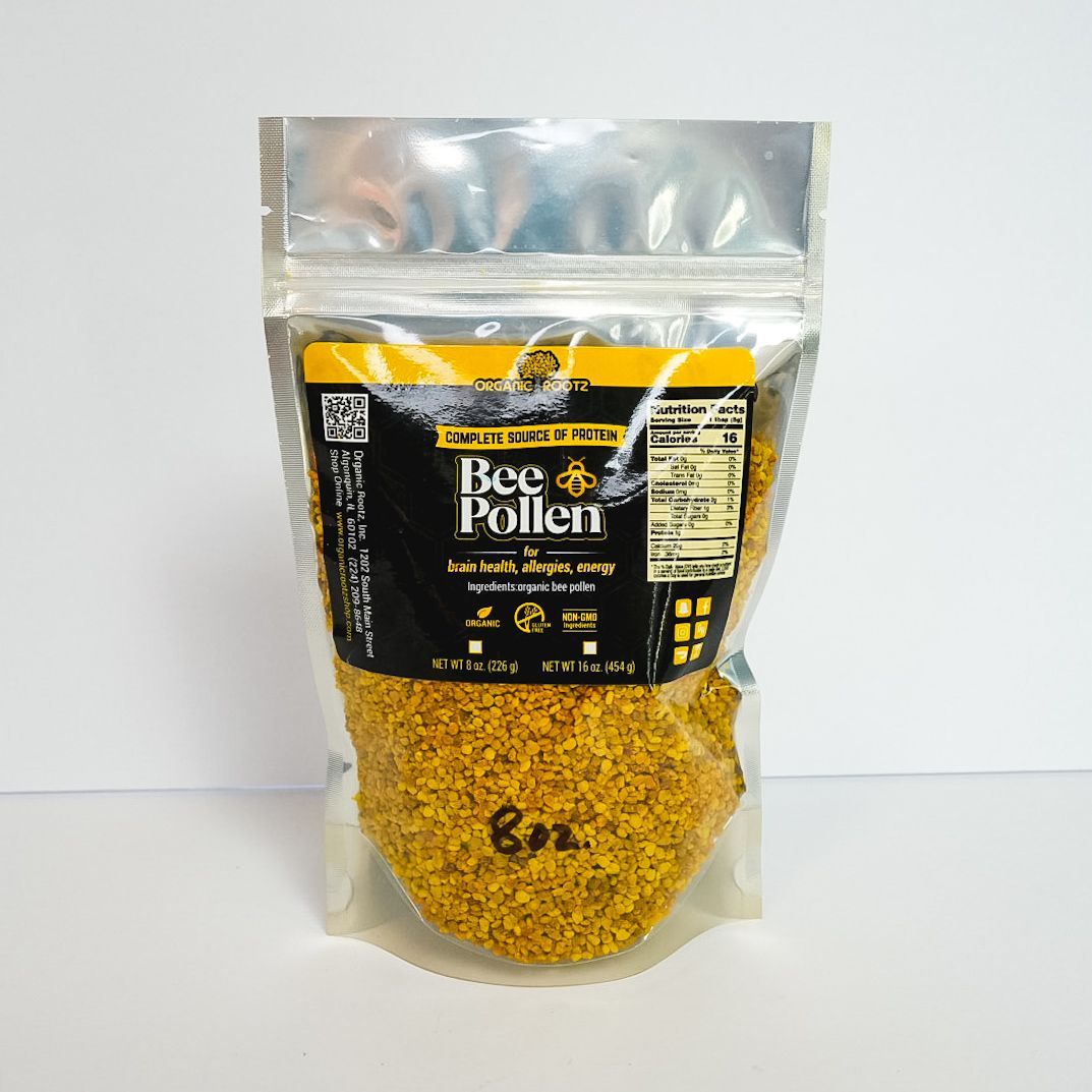 Clear plastic pouch of bee pollen with black and yellow label on a white background