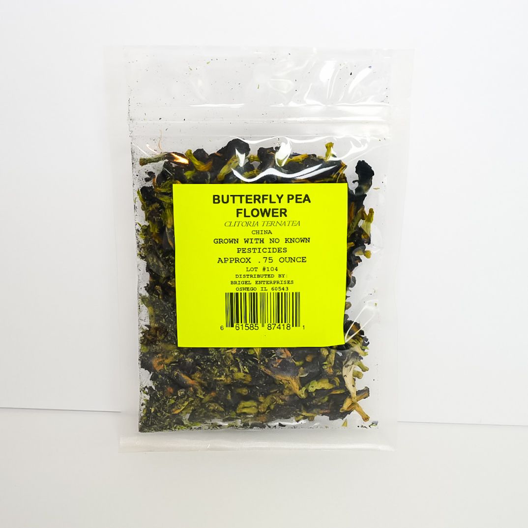 Clear bag of dried butterfly pea flowers with a bright yellow label on a white background