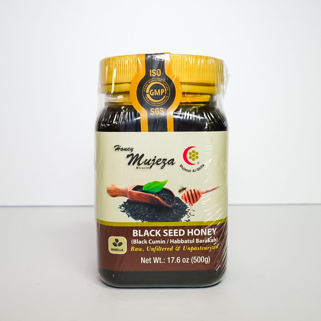Black seed honey jar with yellow lid and beige label on a white background