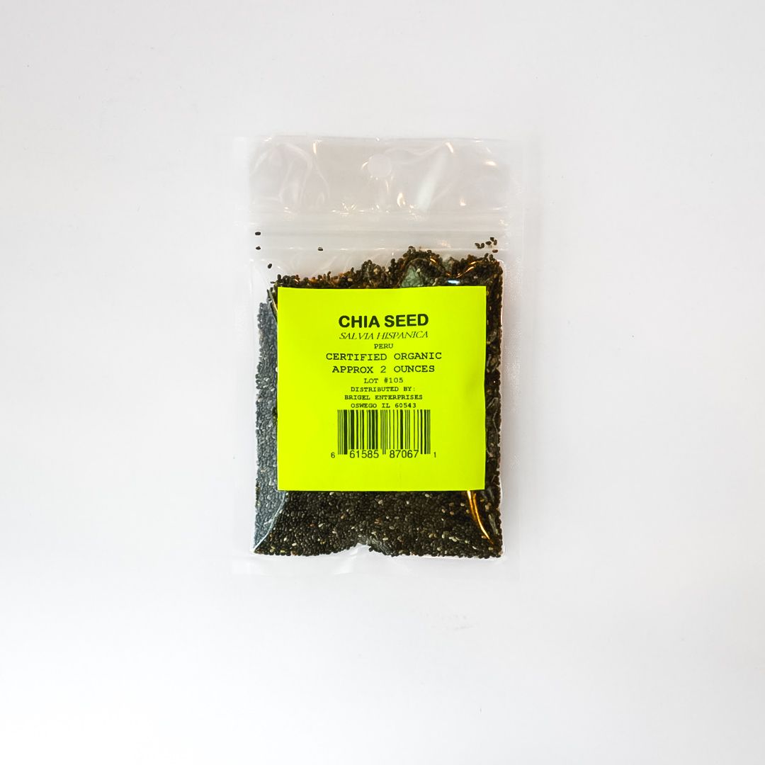 Small clear plastic bag of black chia seeds with a bright yellow label on a white background