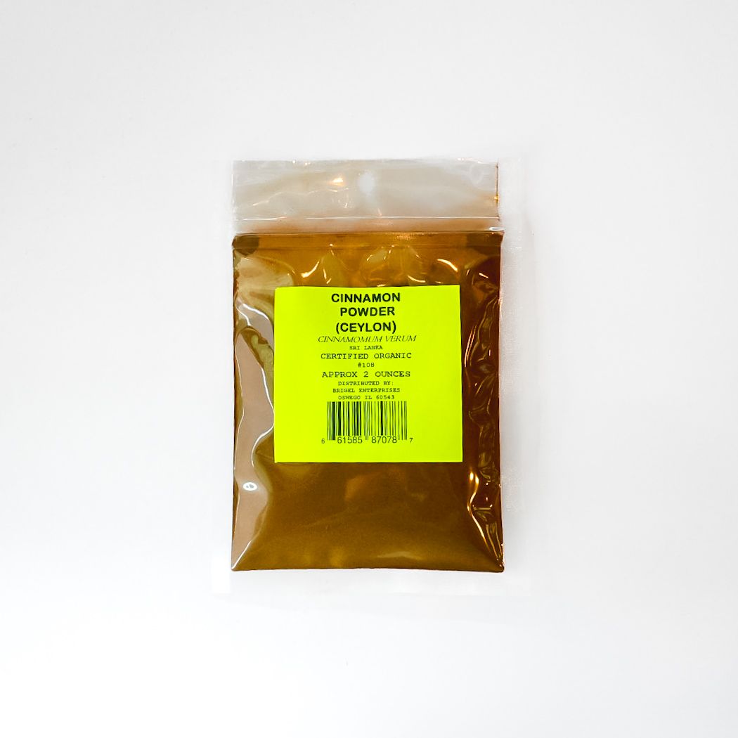 Small clear plastic bag filled with amber liquid and a bright yellow label, on a white background