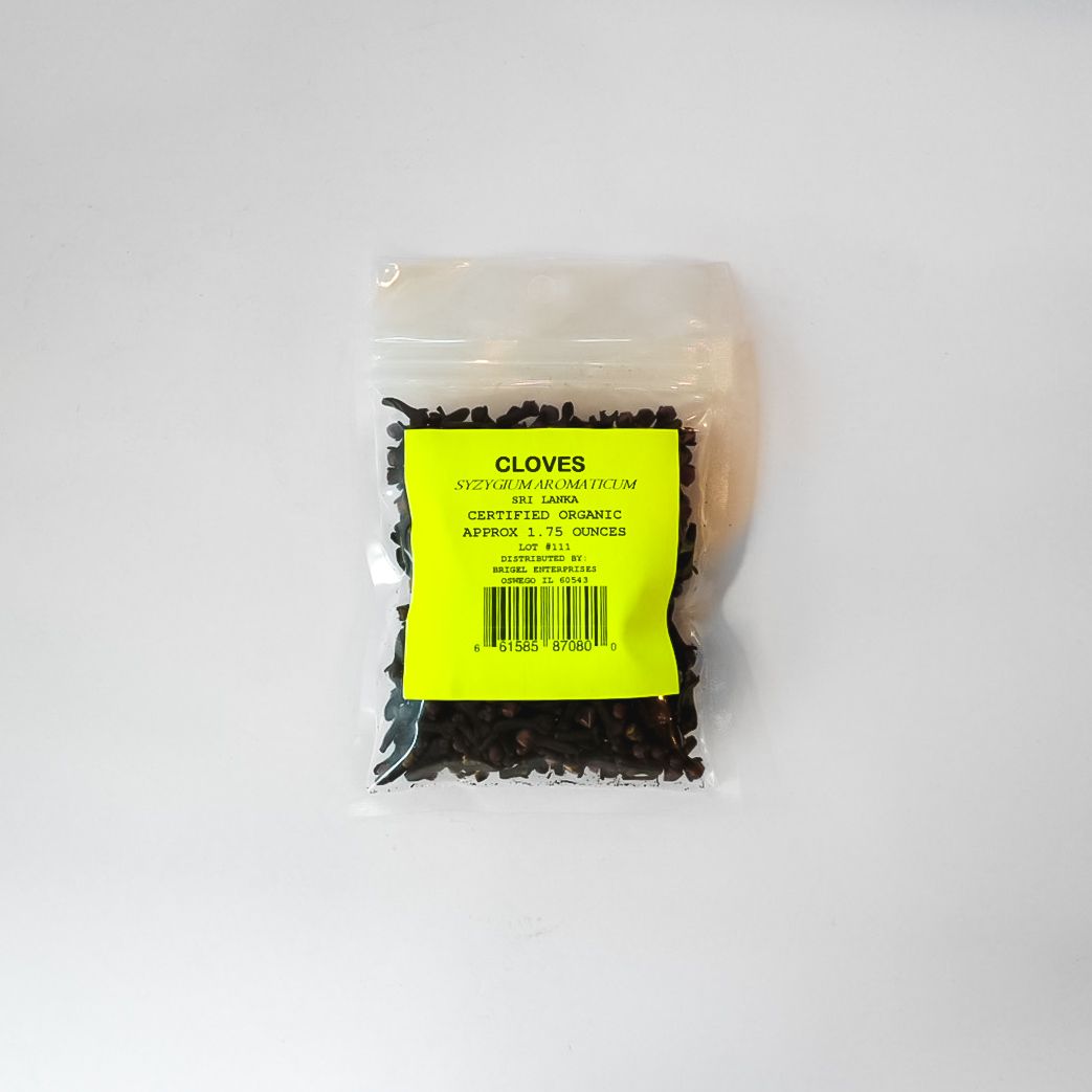 Small clear bag of black gloves with a bright yellow label on a white background